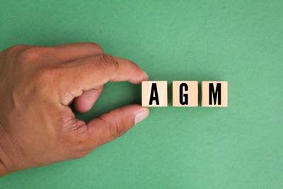 Hand holding the letters agm